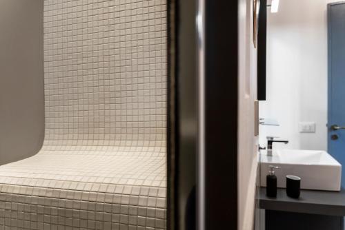 a bathroom with a shower with a sink and a toilet at I CARIZZI in Ragusa