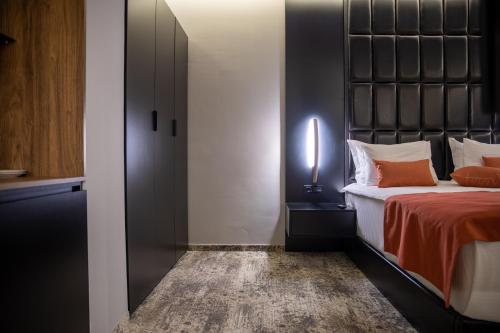 a bedroom with a bed with a black headboard at Palace Hotel & SPA in Mitrovicë