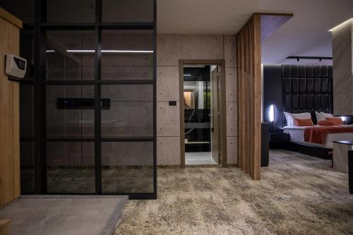 a room with a glass door leading to a bedroom at Palace Hotel & SPA in Mitrovicë