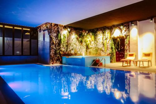 a swimming pool in the middle of a house at Hotel Kocibelli POOL & SPA in Korçë
