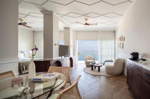 a living room with a table and chairs at Galei Kinneret Hotel in Tiberias