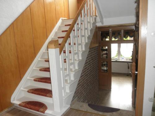 a staircase in a home with wooden walls at Gästehaus Mea Vota in Braunlage