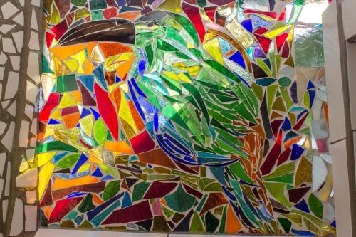 a colorful glass painting of a tree at Cabana del Rio Lejos Pijao, Finca Flora del Rio in Pijao