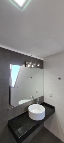 a bathroom with a sink and a mirror at Apartamento frente al mar primera linea de la mansa Pda 26 punta del este penthouse in Punta del Este
