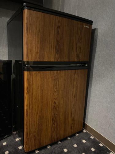a wooden cabinet in the corner of a room at hotel the textile in Gifu