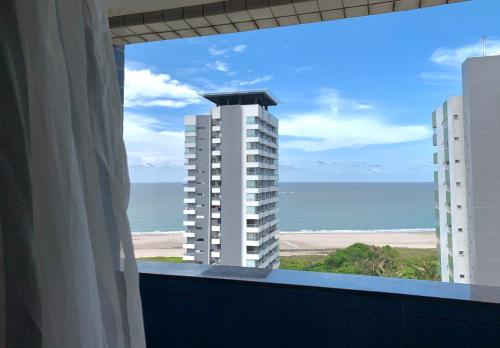 a view of the beach from the balcony of a building at Biarritz temporadalitoranea in São Luís