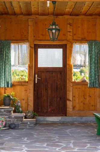 a wooden house with a door and windows at Haus Sonja in Altaussee
