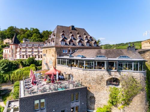 a building with a restaurant on top of it at Hotel Schloss Rheinfels in Sankt Goar