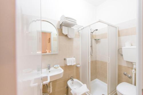a bathroom with a shower and a toilet and a sink at Rabbit Home in Misano Adriatico
