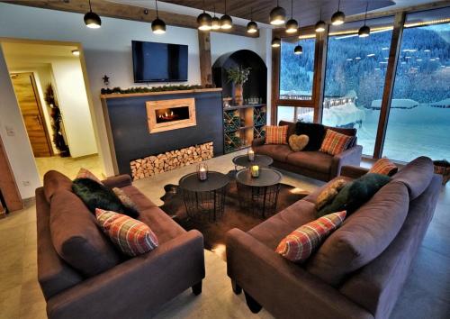 a living room with two couches and a fireplace at Der Trueferhof in Ehrwald
