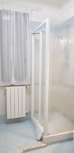 a bathroom with a shower with a window and a mirror at A CASA DEL SOLE in Palaia
