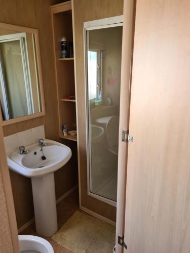 a bathroom with a sink and a shower at 10 Berth on The Chase (Torbay) in Ingoldmells