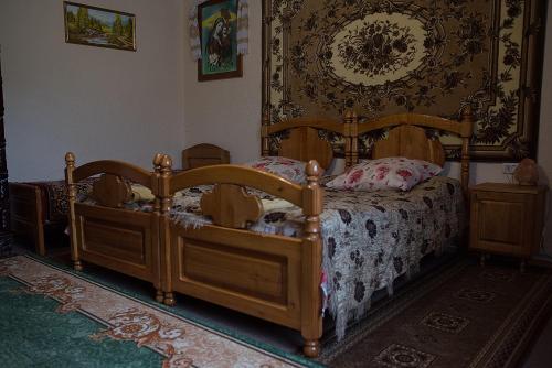 a bedroom with a bed with a wooden frame at Приватна садиба Яблуневий сад 1 in Yaremche