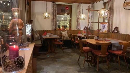 a restaurant with tables and chairs and a candle at Gasthaus Zum Hirschen in Staufen im Breisgau