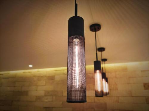 a large glass light fixture hanging from a ceiling at 1st Luxury Warehouse in Cancún