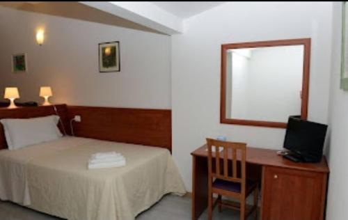 a bedroom with a bed and a desk with a computer at Buon Hotel Bologna Centro - Affittacamere - Self Check-In in Bologna