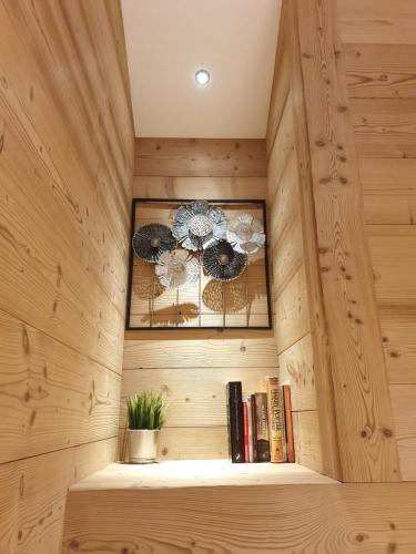 a wooden room with a shelf with books at Chalet le Petit Ramoneur in Châtel
