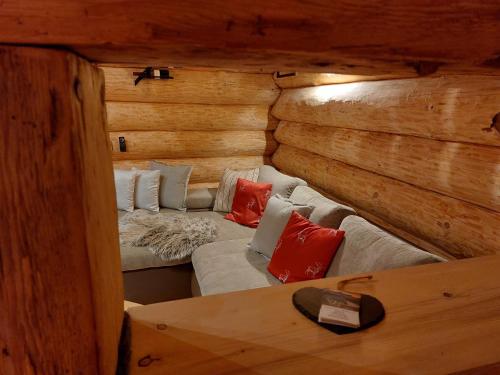 a room with two beds in a log cabin at Apart Lechtraum in Stanzach