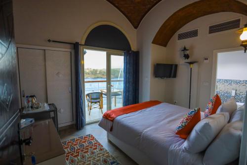 a hotel room with a bed and a balcony at NUB INN in Aswan