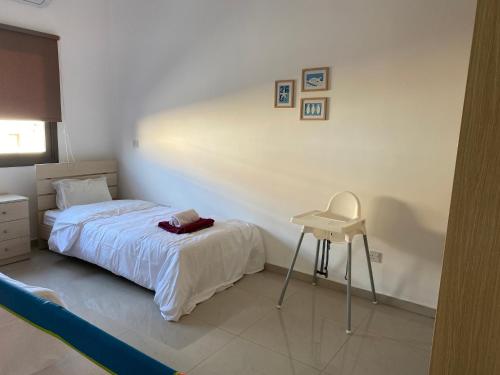 a bedroom with a bed and a table and a chair at Two bedroom Duplex :Mountain and Sea view in Larnaca