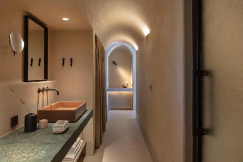 a bathroom with a sink and a mirror at NOS Hotel & Villas in Sifnos