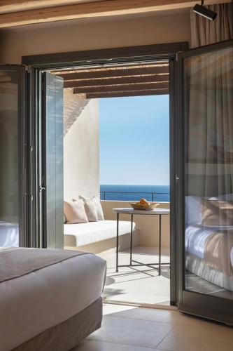 a bedroom with a view of the ocean at NOS Hotel & Villas in Sifnos
