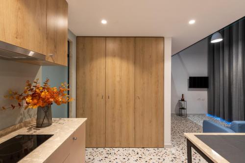 a kitchen with a vase of flowers on a counter at Spa & Pool - Studio Apartments 365 in Tirana