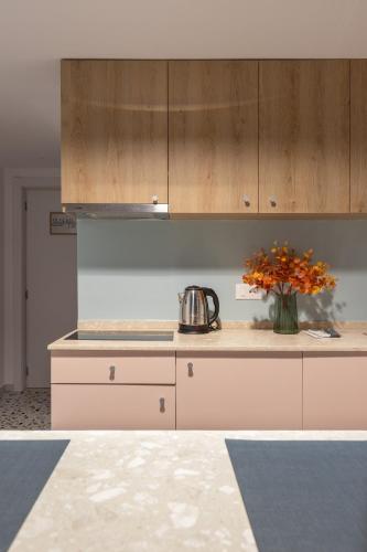 a kitchen with a vase of flowers on a counter at Spa & Pool - Studio Apartments 365 in Tirana