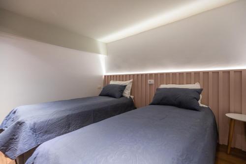 a bedroom with two beds and a table at Spa & Pool - Studio Apartments 365 in Tirana