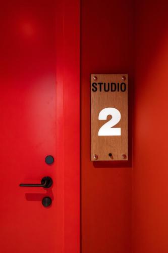 a red door with a sign with the number studio at Spa & Pool - Studio Apartments 365 in Tirana