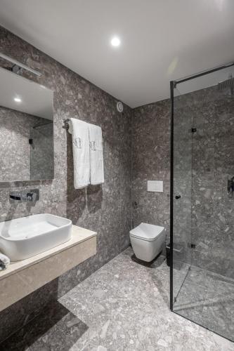 a bathroom with a sink and a toilet and a shower at Spa & Pool - Studio Apartments 365 in Tirana