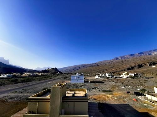a view of a desert with mountains in the background at 228Hostel in Al Ḩamrāʼ