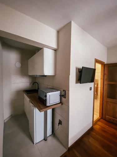 a small kitchen with a sink and a microwave at U Maćka in Białka Tatrzanska