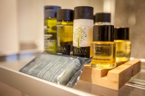 four bottles of essential oils sitting on a shelf at Hotel Bologna in Genova