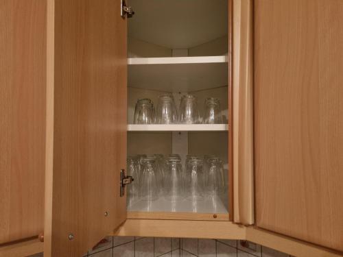 a cupboard filled with clear glass jars at Alina's DIY-Haus St.Jakob in Innere Großrotte