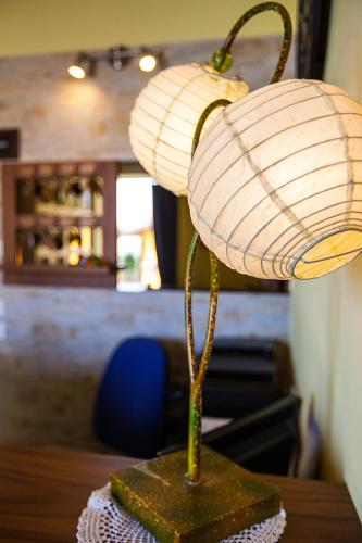 a lamp with two lights on top of a table at Osteria da Cesare e Locanda in Castel San Pietro Terme