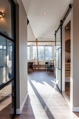 a hallway with glass doors leading to a dining room at Spacious Luxury Loft in Zandvoort
