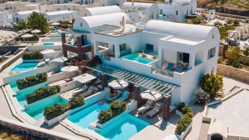 an aerial view of a villa with a swimming pool at Astro Palace Hotel & Suites in Fira