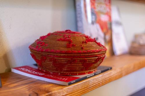 a red hat sitting on top of a shelf at Ladiri - Antica dimora in terra cruda in Sìnnai