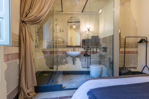 a bathroom with a sink and a mirror at Ladiri - Antica dimora in terra cruda in Sìnnai