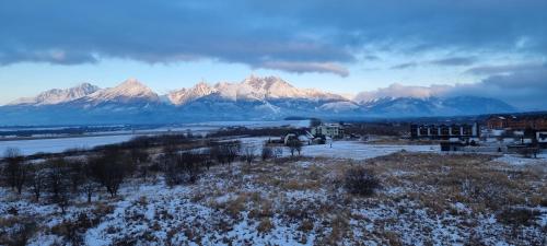 a view of a mountain range with snow on the ground at Sunset View in Kežmarok