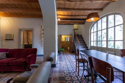 a living room with a couch and a table at Ladiri - Antica dimora in terra cruda in Sìnnai