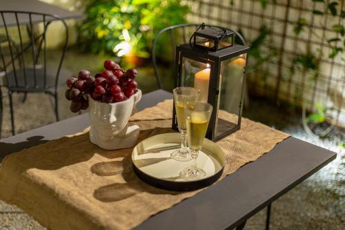 a table with a candle and two glasses of wine at Ladiri - Antica dimora in terra cruda in Sìnnai