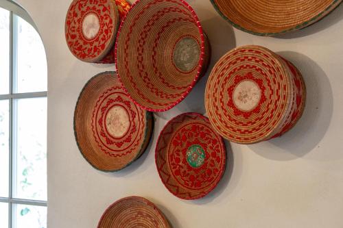 a bunch of plates hanging on a wall at Ladiri - Antica dimora in terra cruda in Sìnnai