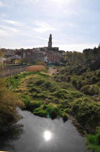 a river in a field with a city in the background at CASA PORTALICO in Jérica