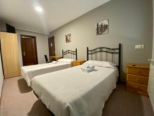 a bedroom with three beds and a dresser at Hotel CASA DEMA in Fresneda