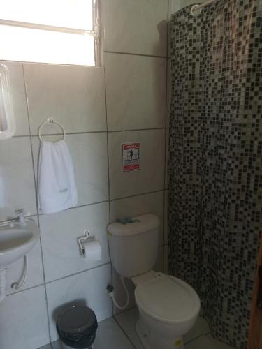 a bathroom with a toilet and a shower and a sink at Casa do Mochileiro Airport Hostel & Pousada in São Gonçalo do Amarante