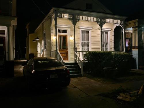 a car parked in front of a house at night at PAUSED - Miss Ruby's Mid-City in New Orleans