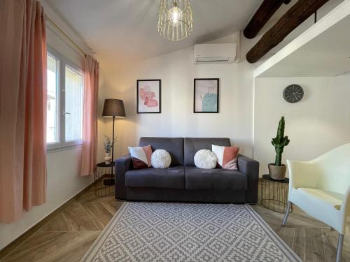 a living room with a couch and a chair at Nice Renting - MASSENA - LOFT - HEART of VIEIL ANTIBES - THE MARKET WITH SEA VIEW in Antibes