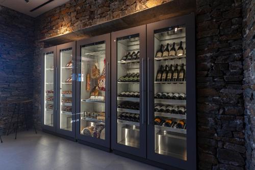 a display case in a store with bottles of wine at NOS Hotel & Villas in Sifnos